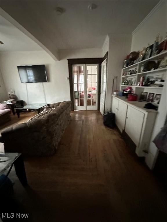 corridor with ornamental molding and dark wood-style flooring