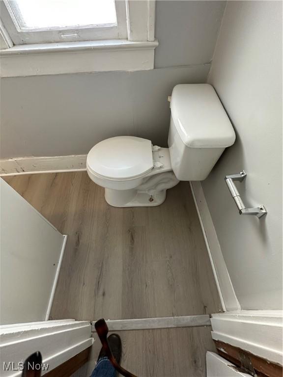 bathroom featuring wood finished floors and toilet