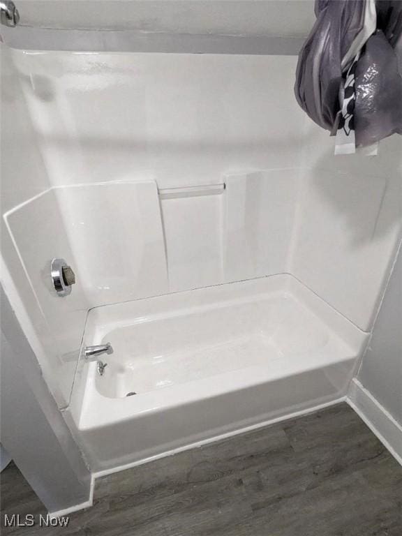 bathroom featuring shower / bath combination and wood finished floors