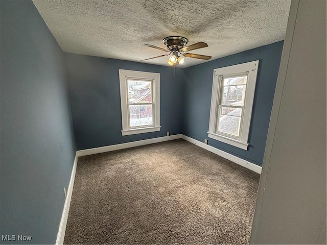 unfurnished room featuring carpet floors, plenty of natural light, and baseboards