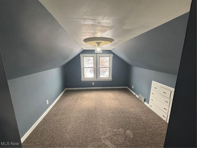 bonus room featuring lofted ceiling, carpet floors, visible vents, and baseboards