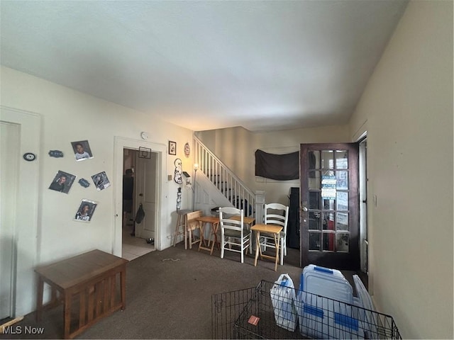 living room featuring stairs and carpet flooring