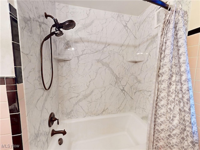 bathroom featuring shower / bath combo with shower curtain and visible vents