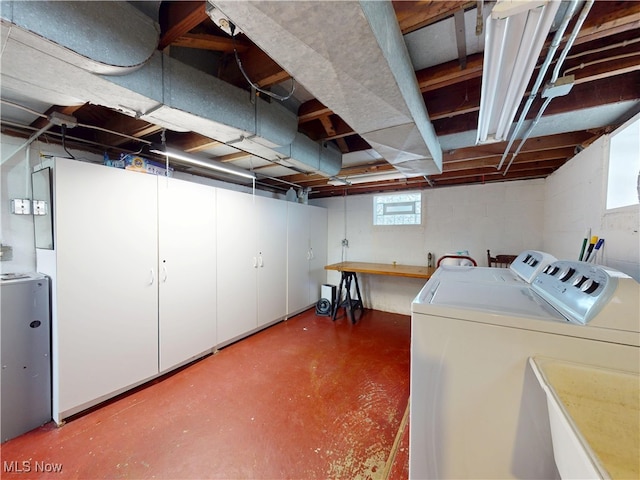 basement with a sink and washing machine and dryer