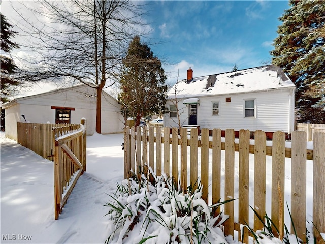 yard covered in snow featuring fence