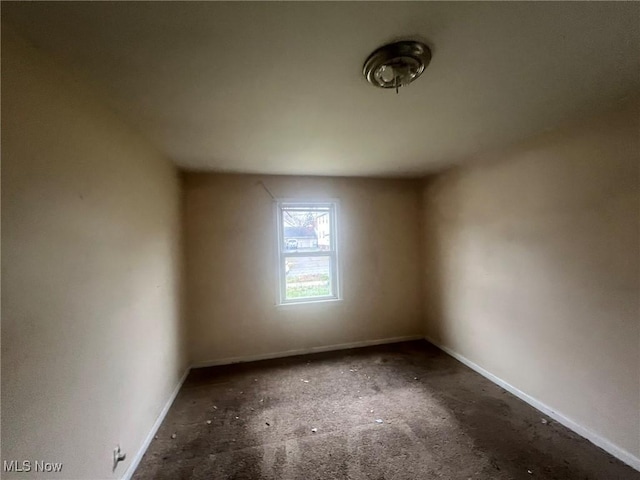 spare room featuring baseboards