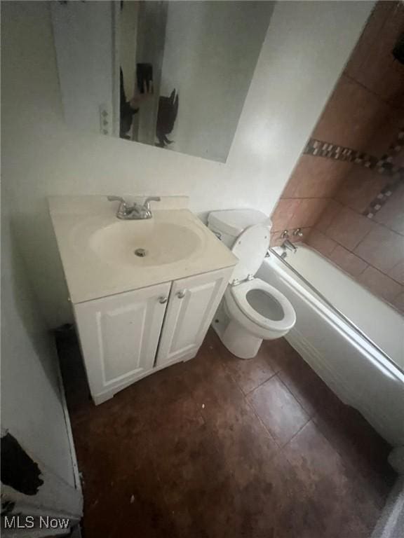 bathroom with toilet, tile patterned flooring, and vanity