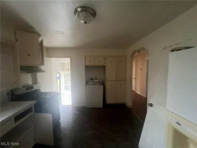 kitchen featuring washer / clothes dryer, light countertops, and cream cabinets