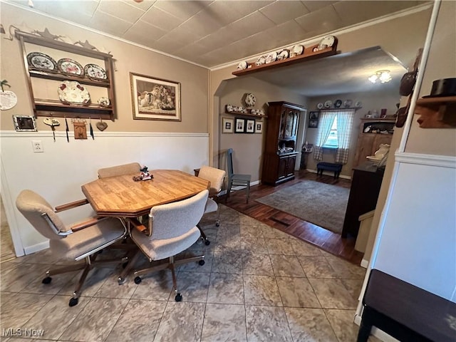 dining space featuring crown molding