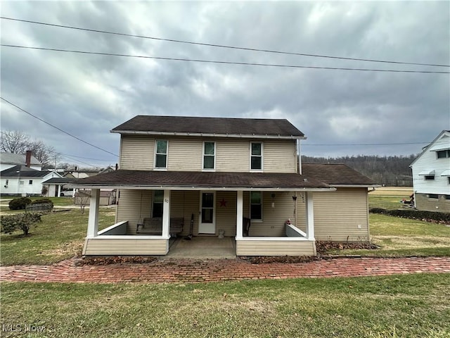 exterior space featuring a porch and a front yard