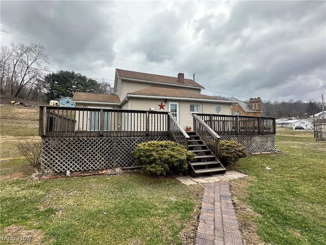 rear view of property with a lawn and a wooden deck