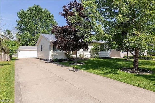 single story home with a front yard and a detached garage