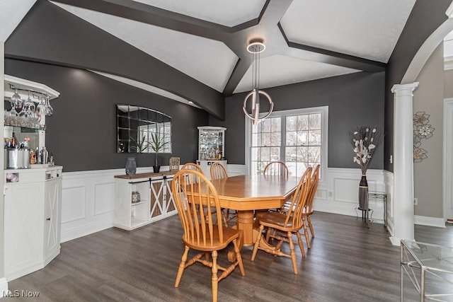 dining room with dark wood-type flooring, arched walkways, lofted ceiling, and ornate columns