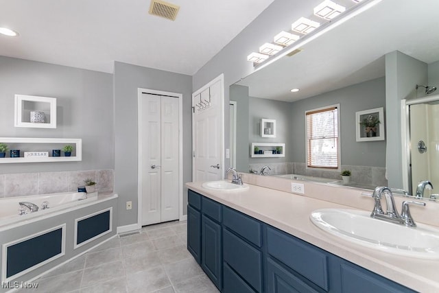 full bathroom featuring a closet, visible vents, a sink, and double vanity