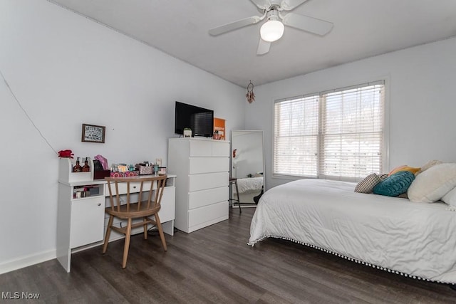 bedroom featuring baseboards and dark wood-style flooring