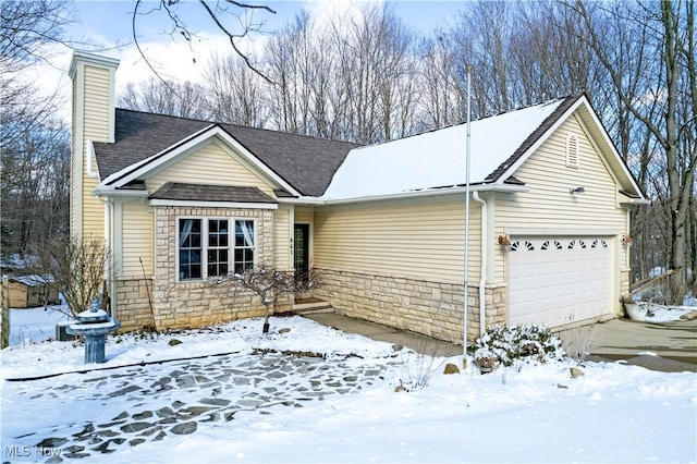 ranch-style house featuring a garage, stone siding, a shingled roof, and a chimney