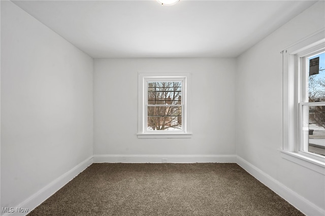 carpeted spare room with baseboards