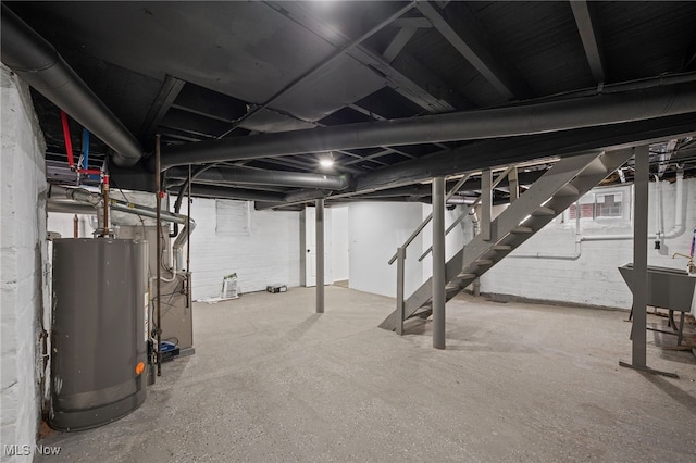 unfinished basement featuring stairway, gas water heater, and a sink