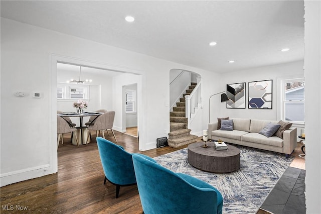 living room with recessed lighting, dark wood-style flooring, baseboards, and stairs