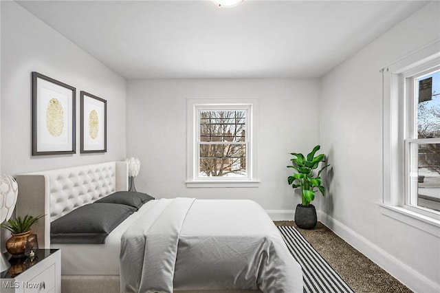 bedroom featuring carpet and baseboards