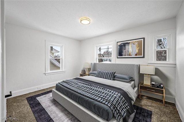 bedroom featuring carpet flooring, a textured ceiling, and baseboards