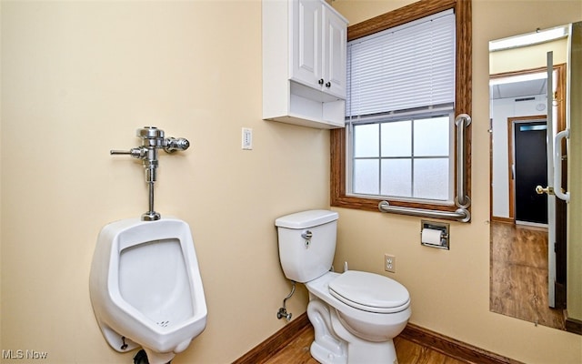 bathroom featuring toilet, wood finished floors, and baseboards