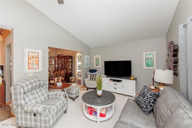 carpeted living room with vaulted ceiling