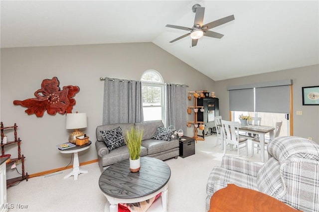 carpeted living room featuring lofted ceiling, a ceiling fan, and baseboards