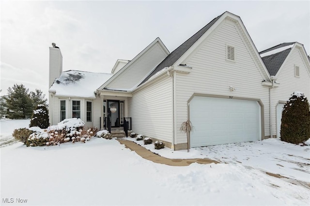 view of front of property with a garage and a chimney