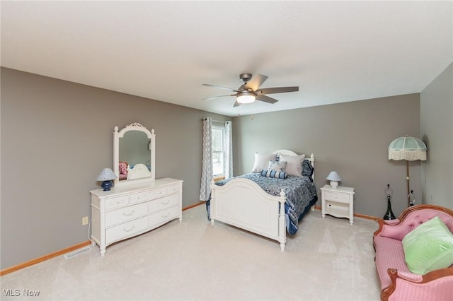 bedroom with light carpet, baseboards, visible vents, and ceiling fan