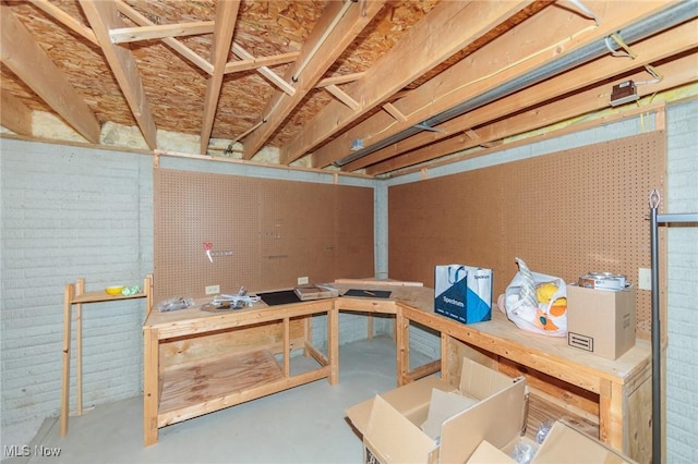 unfinished basement featuring a workshop area