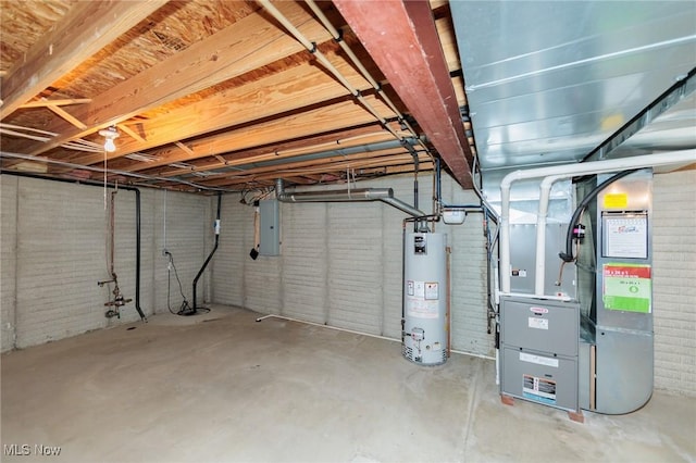 unfinished below grade area featuring brick wall, gas water heater, electric panel, and heating unit