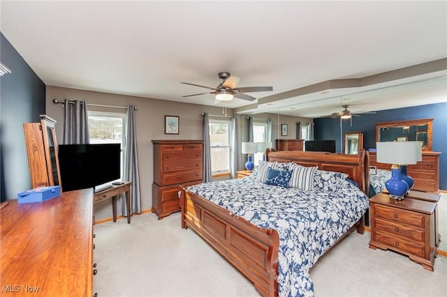 bedroom featuring light carpet and baseboards