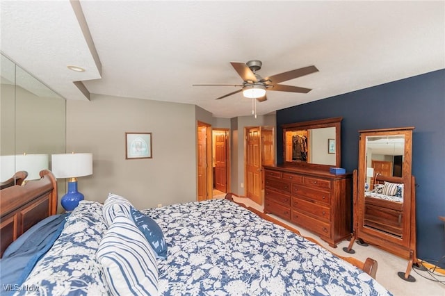 bedroom with light carpet and ceiling fan