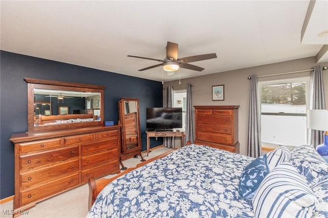 bedroom with a ceiling fan and light carpet