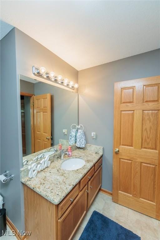 bathroom featuring baseboards and vanity