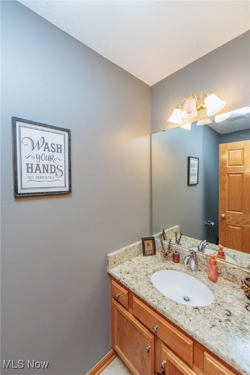 bathroom with baseboards and vanity