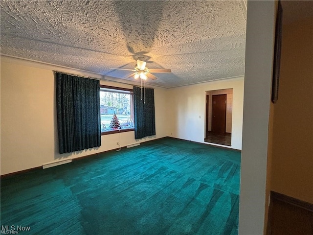 empty room with a textured ceiling, dark colored carpet, visible vents, and a ceiling fan