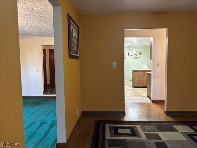 hallway with baseboards and light wood finished floors