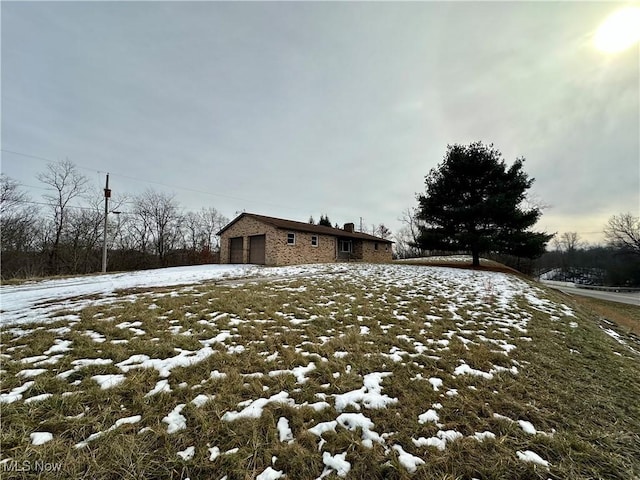 snow covered property with a garage