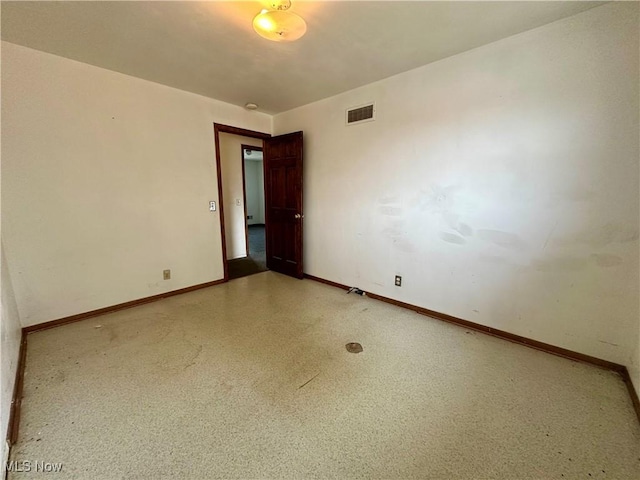 unfurnished room featuring visible vents and baseboards