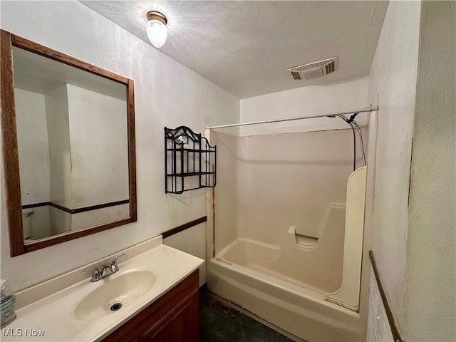 full bath with visible vents, vanity, and shower / tub combination