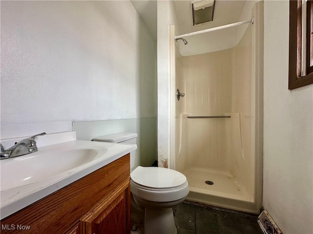 full bathroom with a stall shower, vanity, toilet, and tile patterned floors