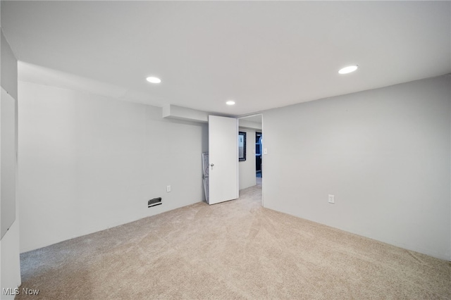 finished basement with recessed lighting and light colored carpet