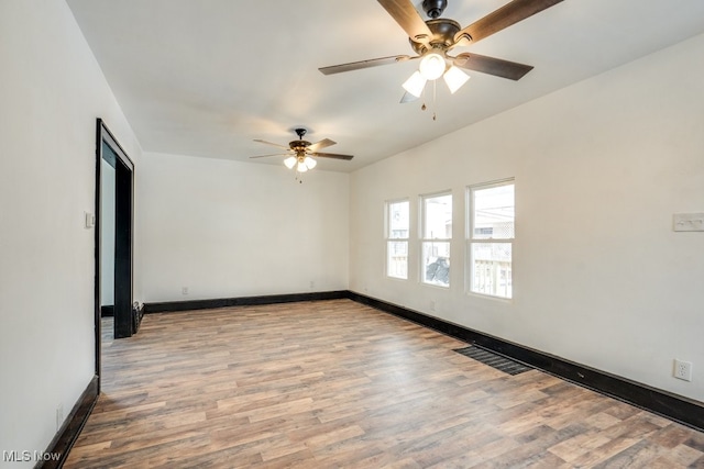 empty room featuring baseboards, visible vents, ceiling fan, and light wood finished floors