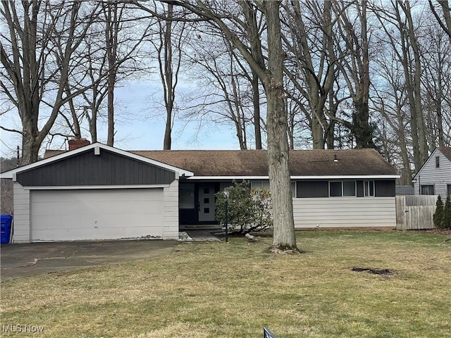 view of front of property with a garage and a front lawn