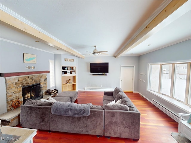 living room featuring ornamental molding, wood finished floors, and a stone fireplace