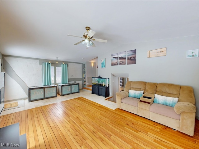 unfurnished living room with lofted ceiling, wood-type flooring, and a ceiling fan