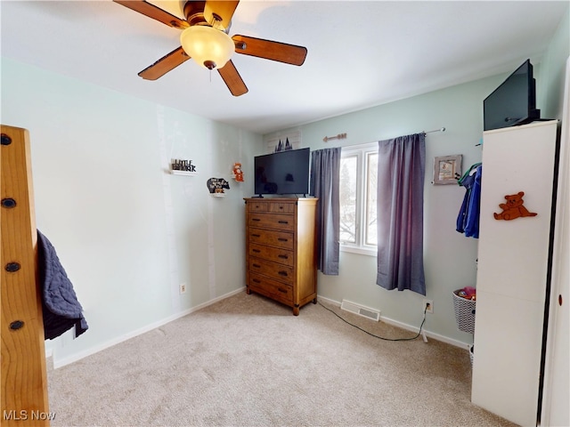 bedroom with carpet floors, a ceiling fan, visible vents, and baseboards