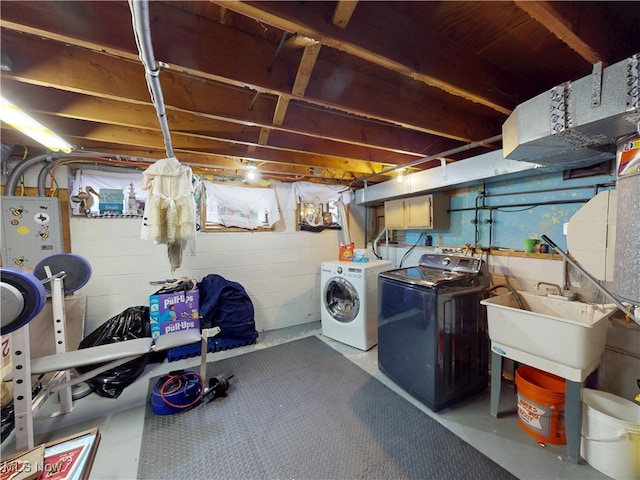 unfinished basement featuring a sink and washer and dryer